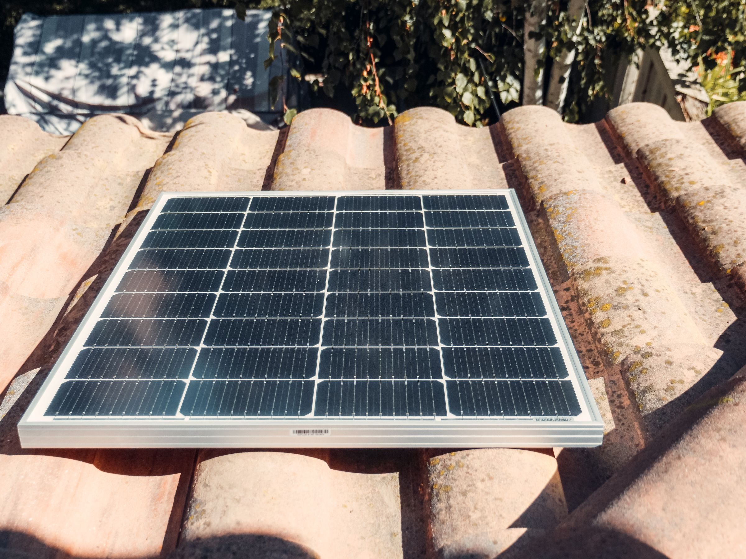 A small solar panel mounted on a house wall