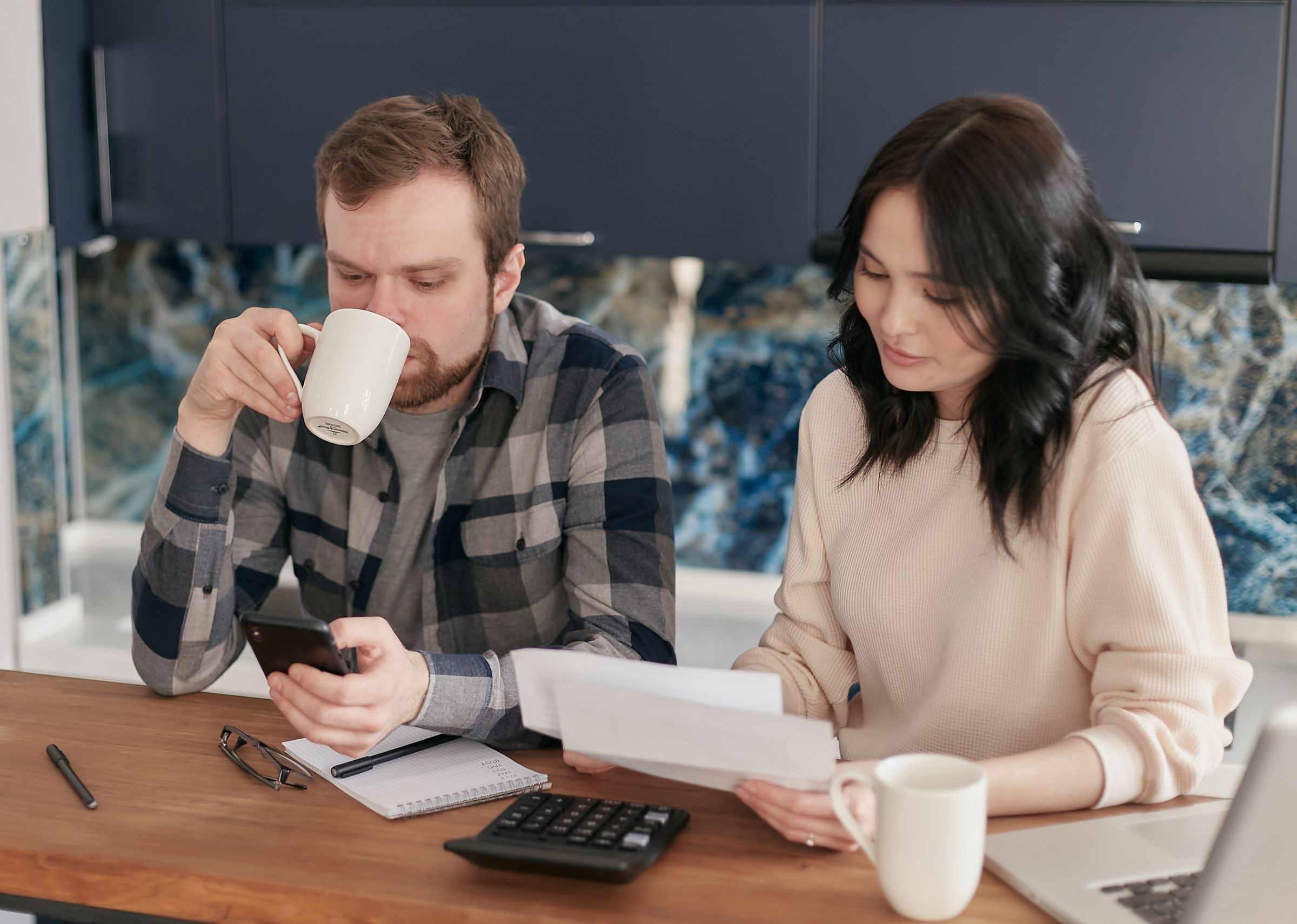 A couple going through an electricity bill at the kitchen table