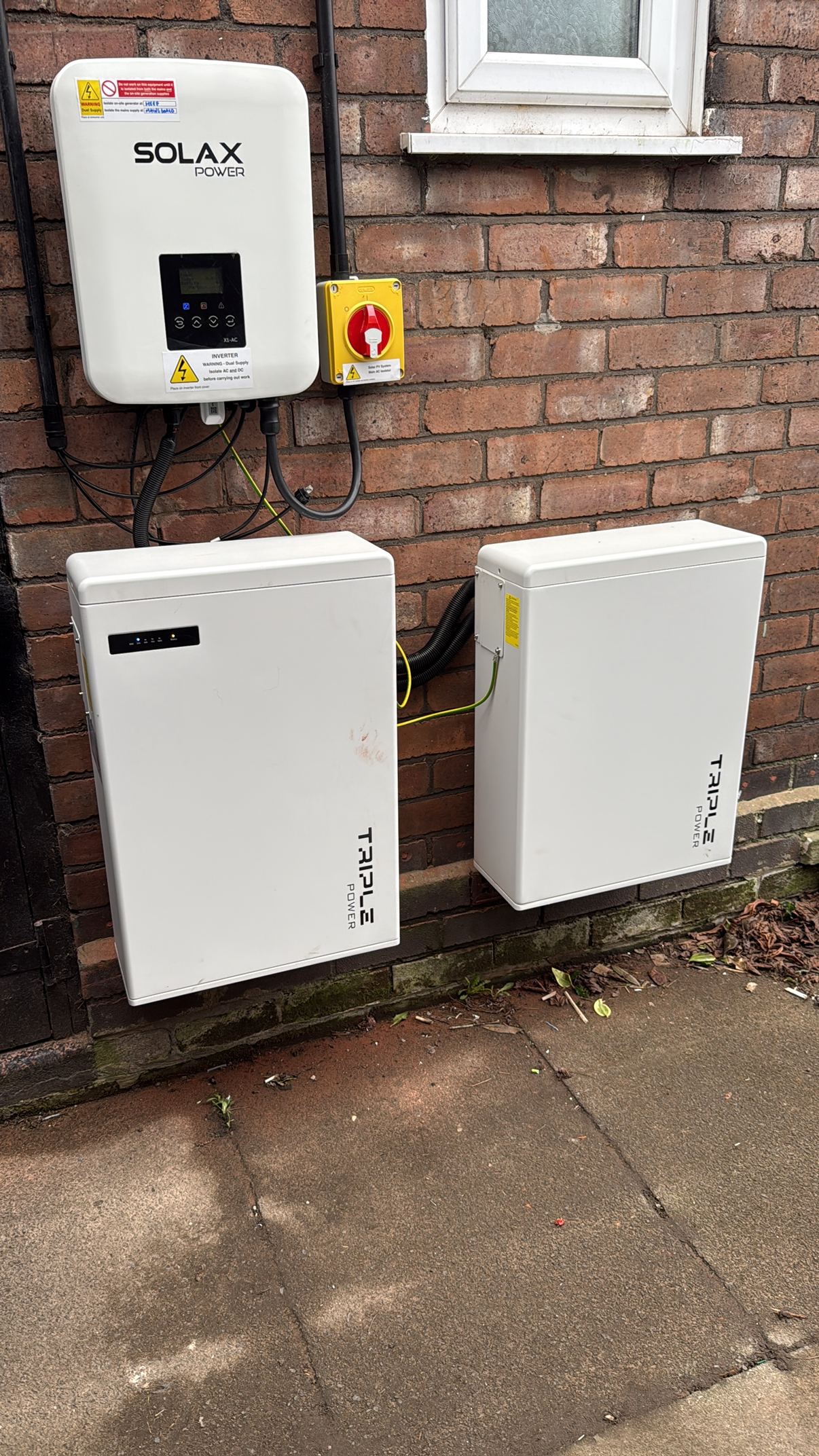 A battery inverter and two batteries we fitted on the outside wall of a home